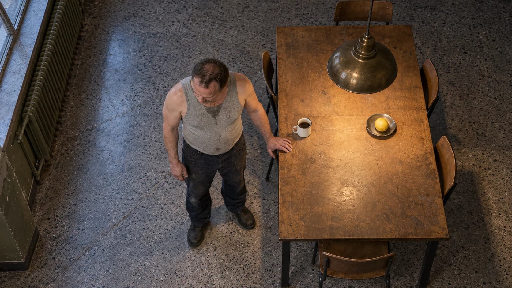 A high view looks down at Brutalisti, the table, mug and lemon, revealing the terrazzo floor.